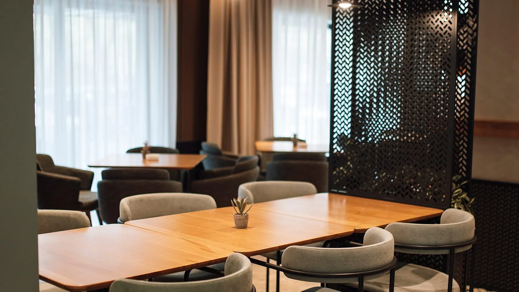 Inside the empty ground floor, wide, light from the street door, where the counter will go.